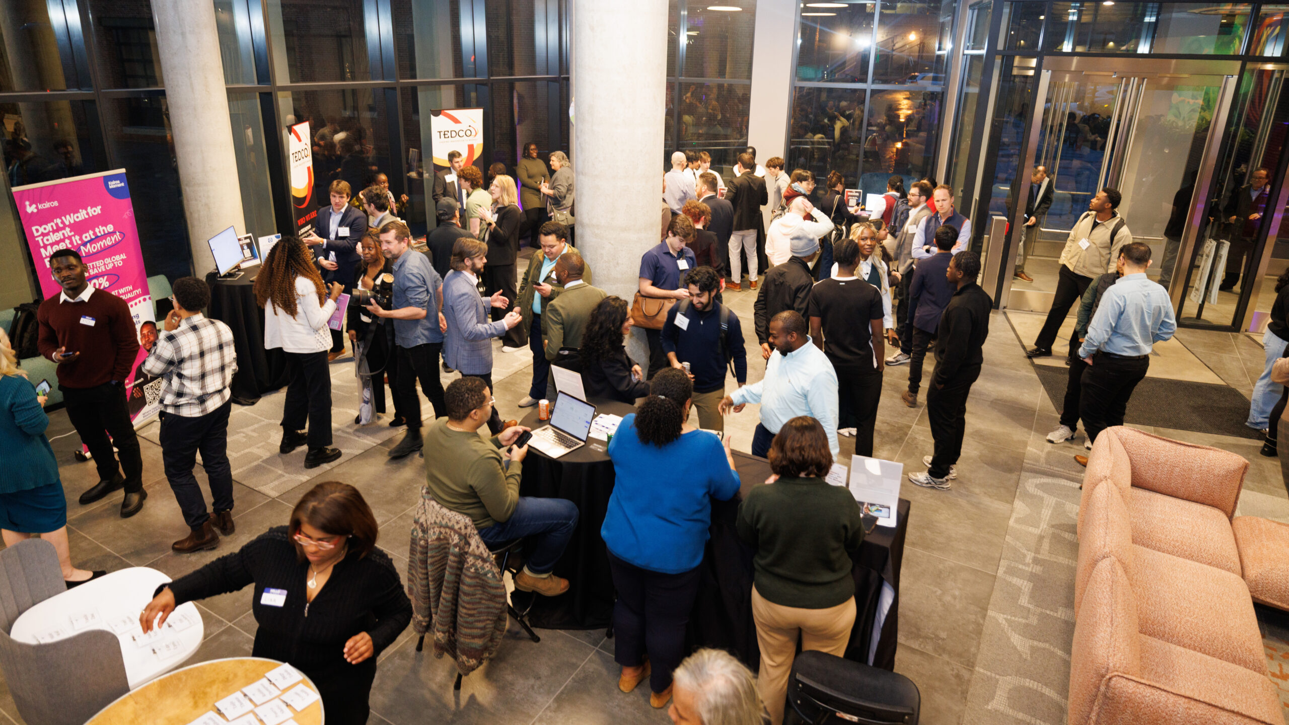 People milling about in a concourse during an expo hall for startups