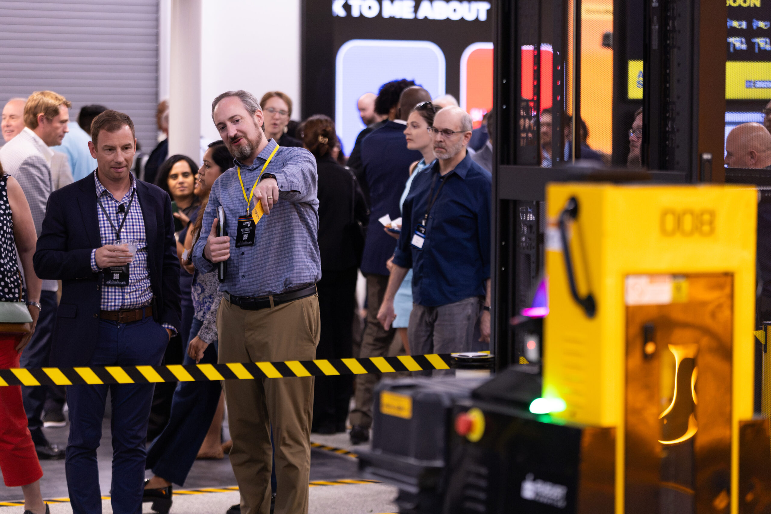 Attendees at the Advanced Manufacturing Exchange watch a demonstration of an autonomous warehouse robot at Stanley Black & Decker's Experience & Innovation Center.